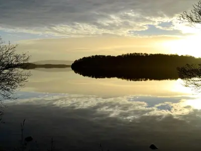 a view of a lake at sunset at Inn Cottage in Glendevon