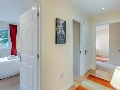 a bedroom with a bed and a walk in closet at Barn Owl Cottage - 27941 in Stirling