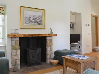 a living room with a fireplace and a table at Westerton Lodge - Srrh in Crieff