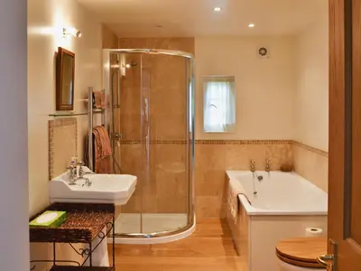 a bathroom with a shower and a sink and a tub at Westerton Lodge - Srrh in Crieff