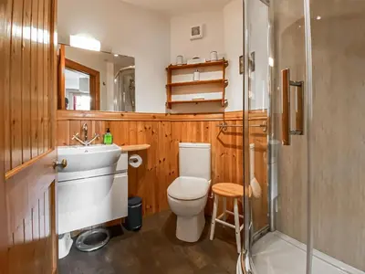a bathroom with a toilet and a sink and a shower at Garden Cottage in Linlithgow