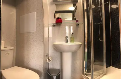a bathroom with a sink and a shower and a toilet at Cruachan Guest House in Edinburgh