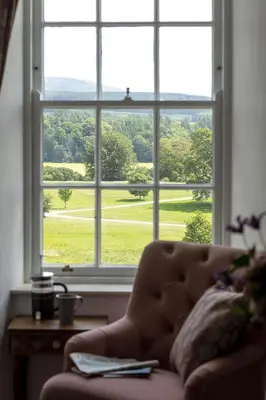 a couch sitting in front of a large window at East Wing in Thornhill