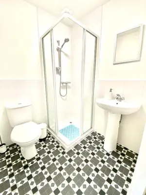 a bathroom with a shower and a toilet and a sink at Lochindaal - Beautiful, Spacious 4 Bedroom House in Kintyre in Whitehouse