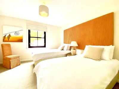 a hotel room with two beds and a window at Lochindaal - Beautiful, Spacious 4 Bedroom House in Kintyre in Whitehouse