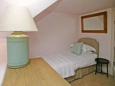 a bedroom with a bed and a lamp on a table at Arkland Mill in Corsock