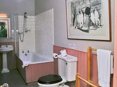 a bathroom with a toilet and a tub and a sink at Marwhin Cottage - Swws in Kirkpatrick Durham