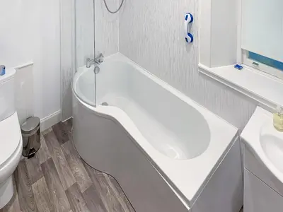 a white bath tub in a bathroom with a toilet at Dunmaghlas in Pirnmill
