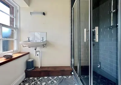 a bathroom with a sink and a glass shower at Eckford House in Dunoon
