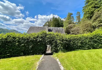 a hedge leading to a house in a field at Eckford House in Dunoon