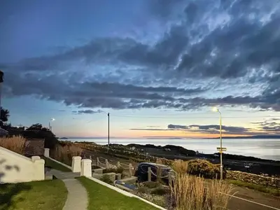 a view of the ocean under a cloudy sky at Aird Cottage in Dunure