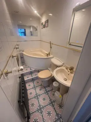 a bathroom with a tub and a toilet and a sink at Bayside - Breathtaking views of the Clyde in Rothesay