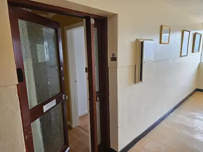 an open door in a room with a hallway at Snug - Colquhoun Square Apartment in Helensburgh