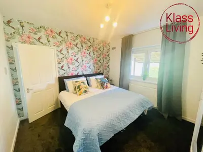 a small bedroom with a bed and a window at Mitchell Apartment by Klass Living Coatbridge in Coatbridge
