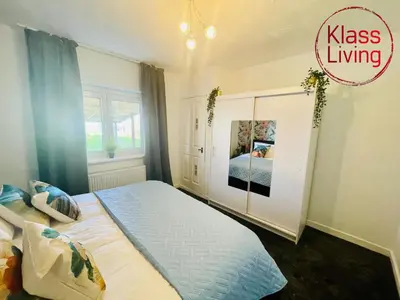 a bedroom with a king sized bed and a window at Mitchell Apartment by Klass Living Coatbridge in Coatbridge