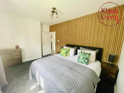 a bedroom with a large white bed with pillows at Mitchell Apartment by Klass Living Coatbridge in Coatbridge