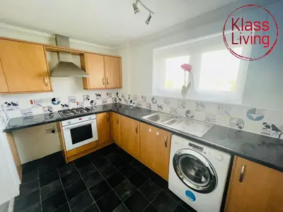 a kitchen with a washer and a washing machine at Mitchell Apartment by Klass Living Coatbridge in Coatbridge