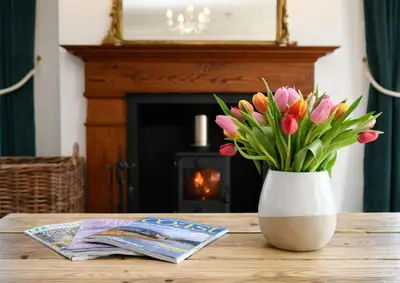 a vase filled with pink tulips sitting on a table at Achalic Farm House in Lerags