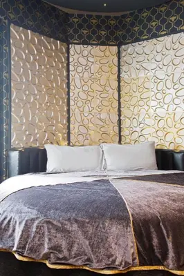 a bedroom with a bed and a wall with patterns at Falls of Lora Hotel in Oban
