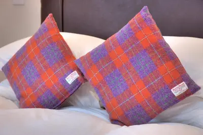 two pillows sitting on top of a bed at Falls of Lora Hotel in Oban