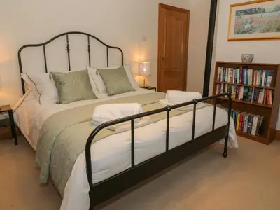 a bedroom with a bed and a book shelf at 5 St Mary's Church in Moffat