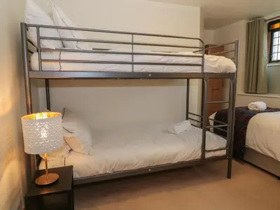 two bunk beds in a room with a lamp at 5 St Mary's Church in Moffat