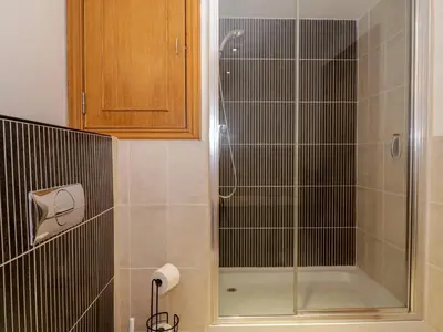 a shower with a glass door in a bathroom at 5 St Mary's Church in Moffat