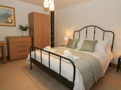 a bedroom with a large bed and a dresser at 5 St Mary's Church in Moffat