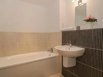 a bathroom with a sink and a toilet and a tub and a sink at 5 St Mary's Church in Moffat