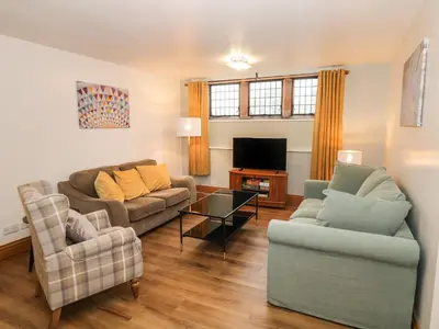 a living room with two couches and a tv at 5 St Mary's Church in Moffat