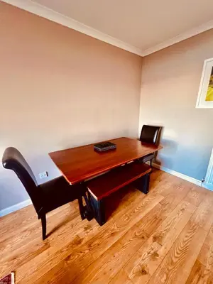 a wooden desk with a bench in a room at 3 Bedroom harbourside apartment, Queensferry, 10 miles from Edinburgh in Queensferry
