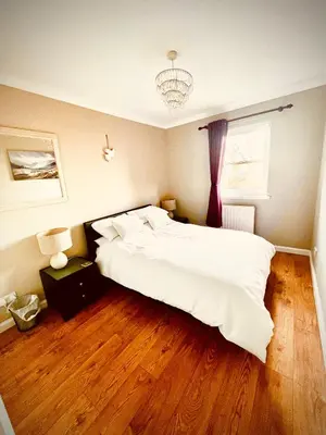 a bedroom with a large white bed and a window at 3 Bedroom harbourside apartment, Queensferry, 10 miles from Edinburgh in Queensferry