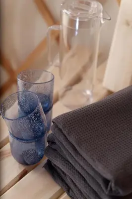 a couple of glasses sitting on a table with towels at Eastside Steading - Family barn in the Pentland Hills, Edinburgh in Penicuik