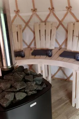 a table with chairs and a pile of rocks at Eastside Byre - Family cottage in the Pentland Hills near Edinburgh in Penicuik