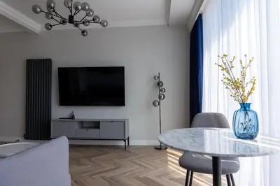 a living room with a table and a tv at Oban Apartments in Oban