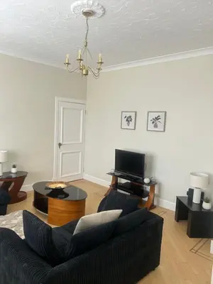 a living room with a couch and a tv at 1L Albert Place Maddiston Road Brightons Falkirk FK2 0JX in Polmont