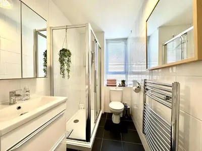 a white bathroom with a sink and a toilet at City Centre Hidden Hideout for 2 in Edinburgh