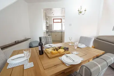 a dining room table with a plate of food on it at Thomas Carlyle Cottage in Thornhill