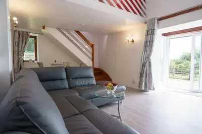 a living room with a couch and a table at Jane Welsh Cottage in Thornhill