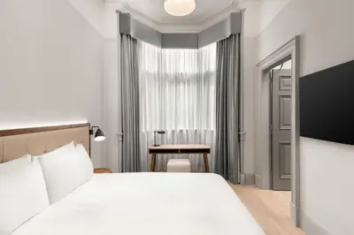 a hotel room with a bed and a table at AC Hotel by Marriott Glasgow in Glasgow