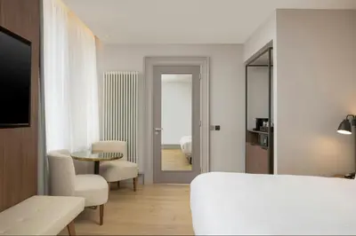 a bedroom with a bed and a table and chairs at AC Hotel by Marriott Glasgow in Glasgow