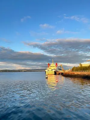 a large boat is docked in a large body of water at THE LAZY LION - Spacious 2 Bedroom - Town Centre Holiday Home Apartment in Port Glasgow