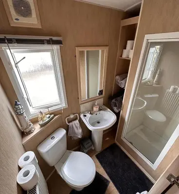 a small bathroom with a toilet and a sink at 4-Bedroom Cosalt Located in Uddingston, Glasgow at Maryville Caravan Site in Uddingston