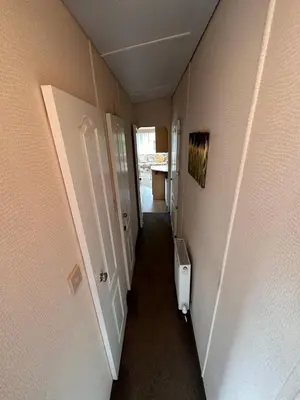 a hallway leading to a hallway with at 4-Bedroom Cosalt Located in Uddingston, Glasgow at Maryville Caravan Site in Uddingston