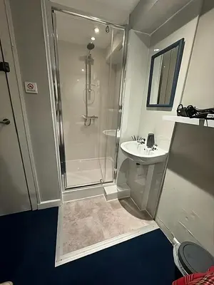 a bathroom with a shower and a sink at New Town Rooms in Edinburgh