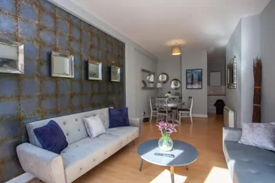 a living room with a couch and a table at Modern and refurbished Flat in Merchant City in Glasgow