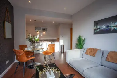 a living room with a couch and a table at 1 Bedroom Apartment in Very Central Location in Glasgow