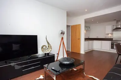 a living room with a large flat screen tv at Fantastic City Centre Flat in Glasgow