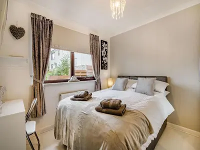 a bedroom with a bed with two towels on it at Highview in Brodick