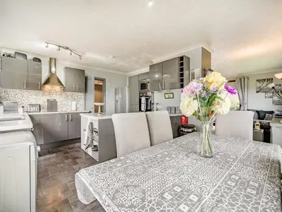 a kitchen with a table with a vase of flowers on it at Highview in Brodick